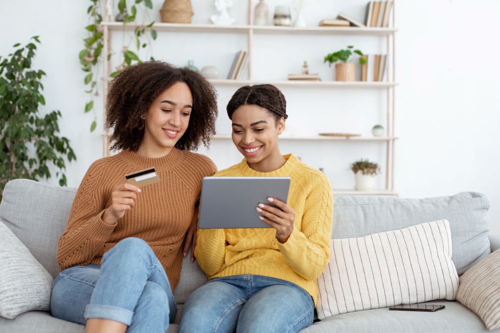 two women sitting on couch