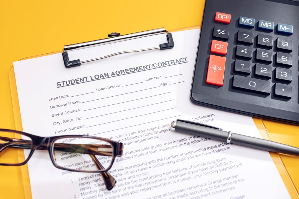 a student loan application on a yellow table