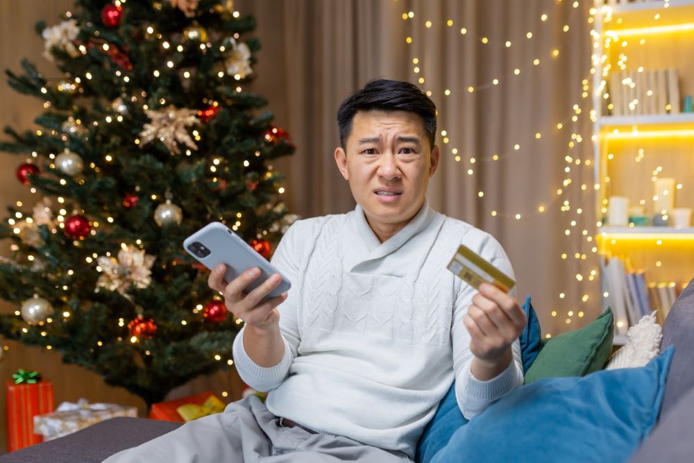 Asian man at home sitting on sofa and looking at camera.