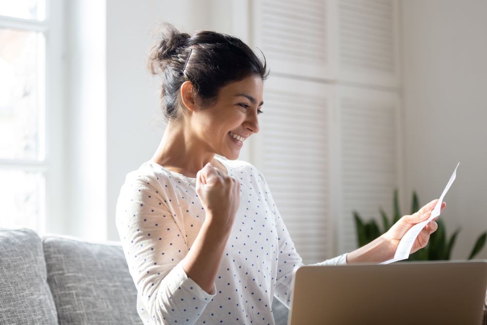 Happy Indian woman reading good news in letter.