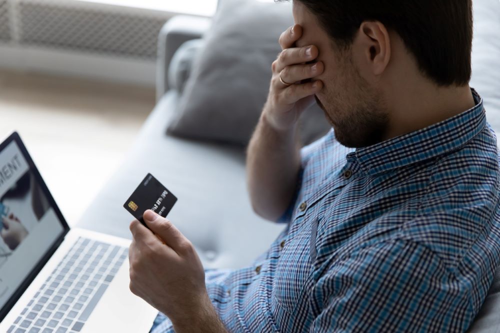 Close up unhappy man having problem with credit card.