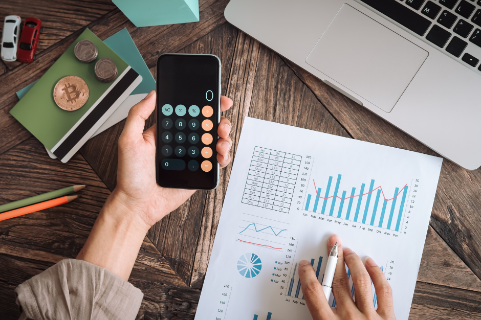 A person holding a smartphone using a calculator app.