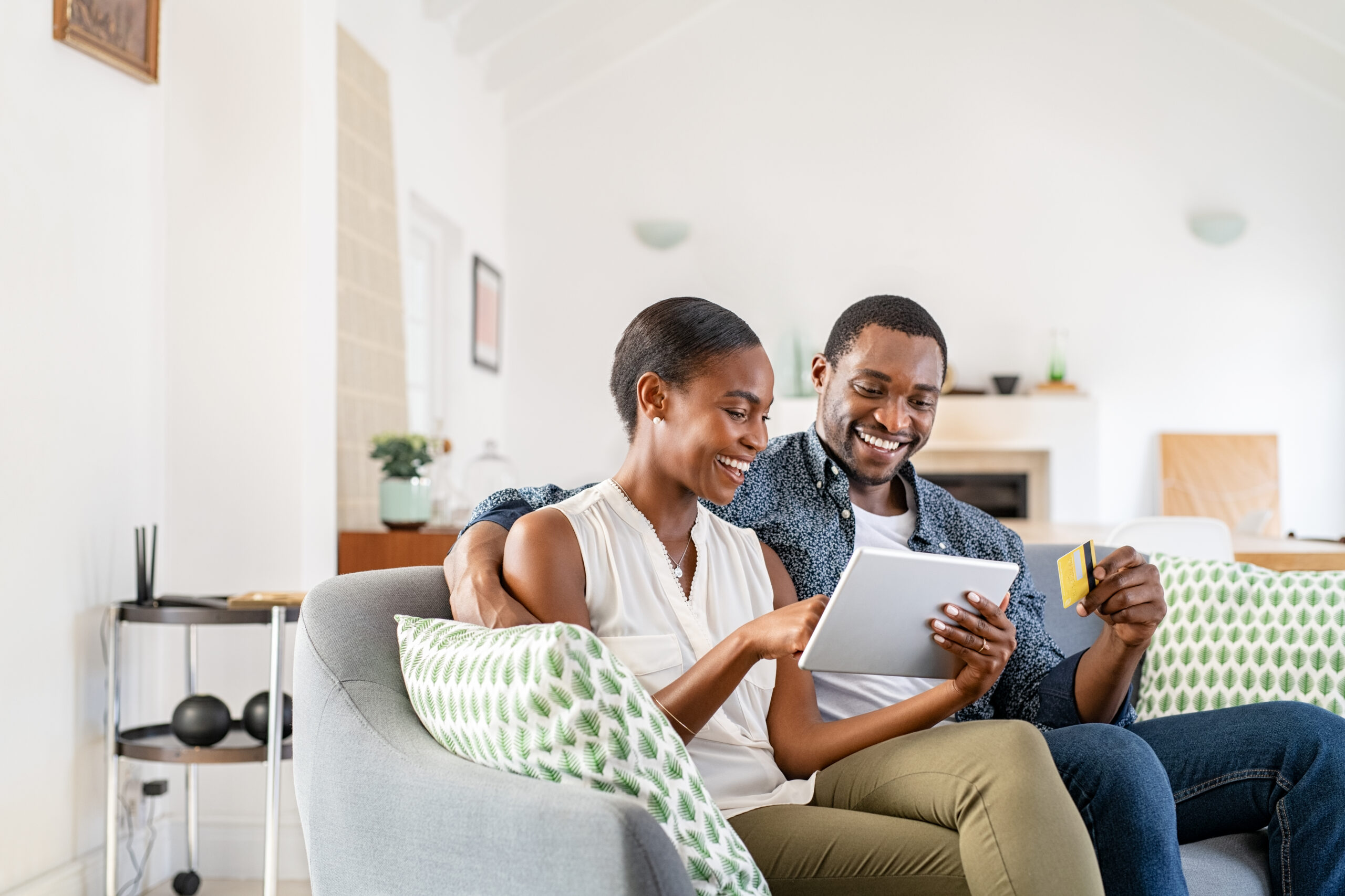 couple doing online shopping with credit card card at home